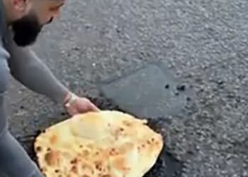 Moment fed-up curry boss plugs gaping pothole with 18-inch mega naan bread to shame council bosses