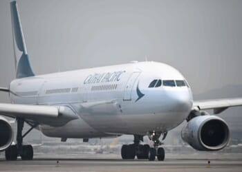 Passenger, 20, arrested after trying to open plane's door mid-air on Cathay Pacific flight