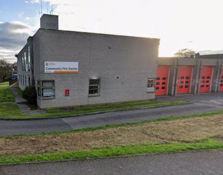 Community Fire Station building with multiple red garage doors.