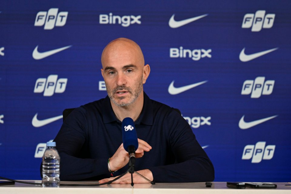 A man with a bald head and short beard speaks at a press conference.
