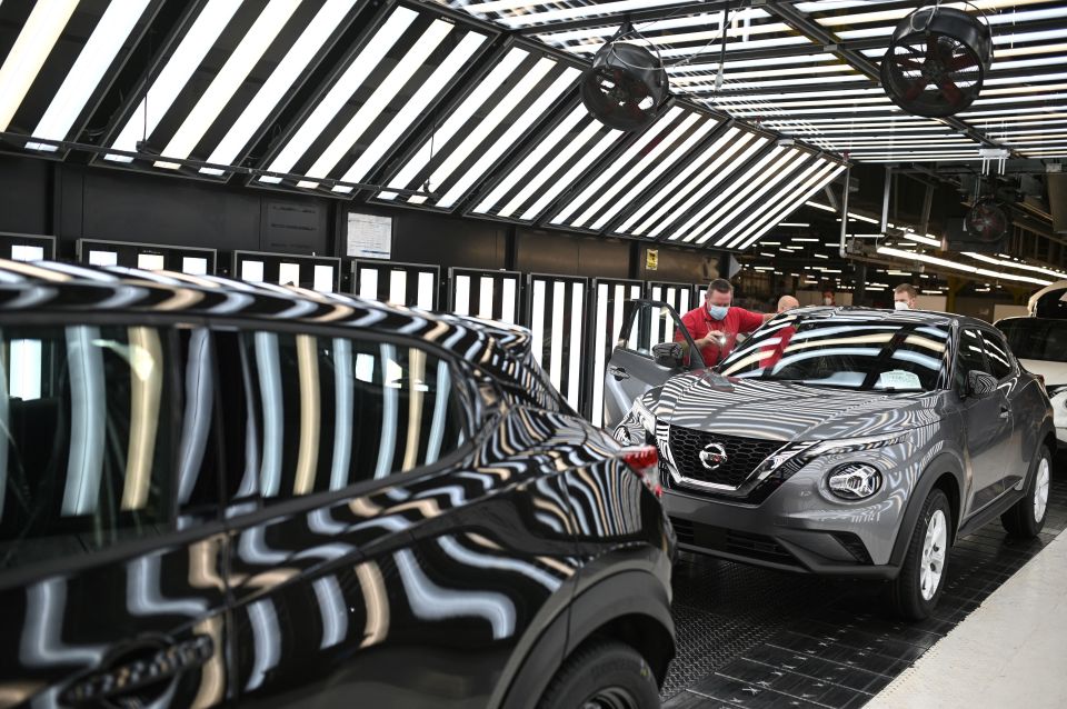 Nissan employees make final checks to cars on the production line at Nissan's plant in Sunderland, north east England.