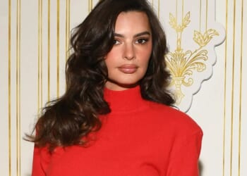 Emily Ratajkowski turns heads as she poses in red minidress and heels at festive event