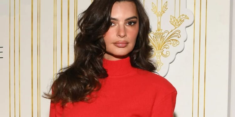 Emily Ratajkowski turns heads as she poses in red minidress and heels at festive event