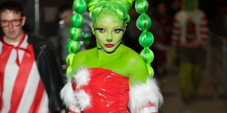 Pop star looks unrecognisable as she transforms into The Grinch for festive birthday bash
