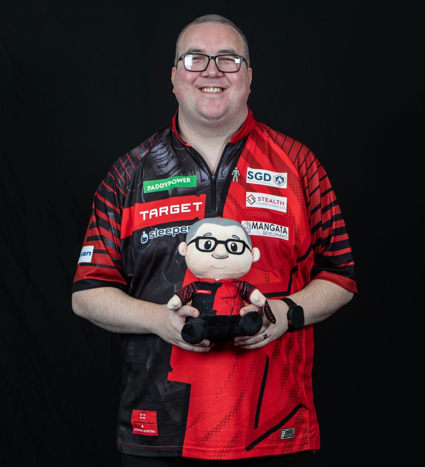 Stephen Bunting holding a plush toy of himself.