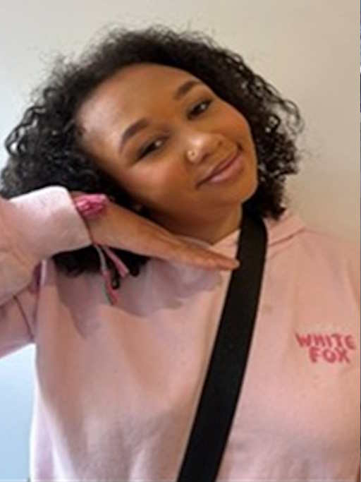 Missing 13-year-old Jemimah Jones, with curly brown hair and a nose piercing, wearing a pink hooded top with "WHITE FOX" printed on it.