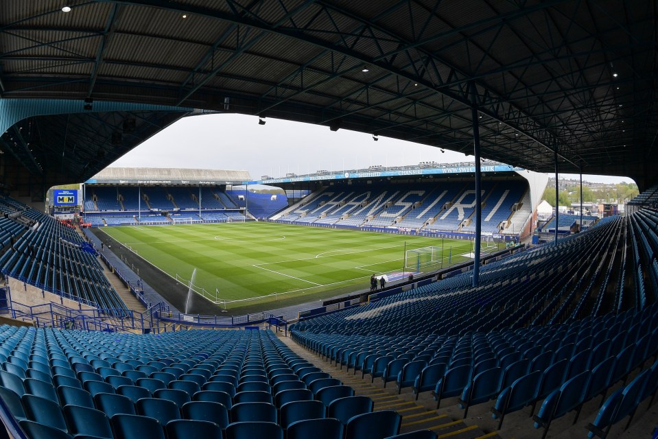 Hillsborough Stadium, home of Sheffield Wednesday, with empty blue seats and a green field.