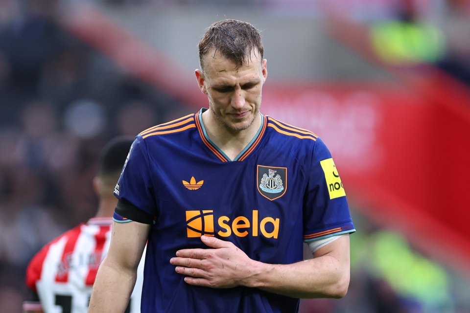 Newcastle United player Dan Burn clutches his chest and looks down, reportedly complaining he couldn't breathe.