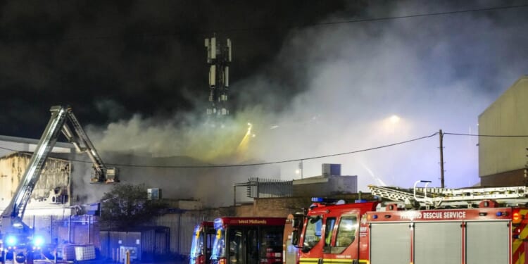 Blaze breaks out at pork scratchings factory as huge flames erupt and 50 firefighters race to scene