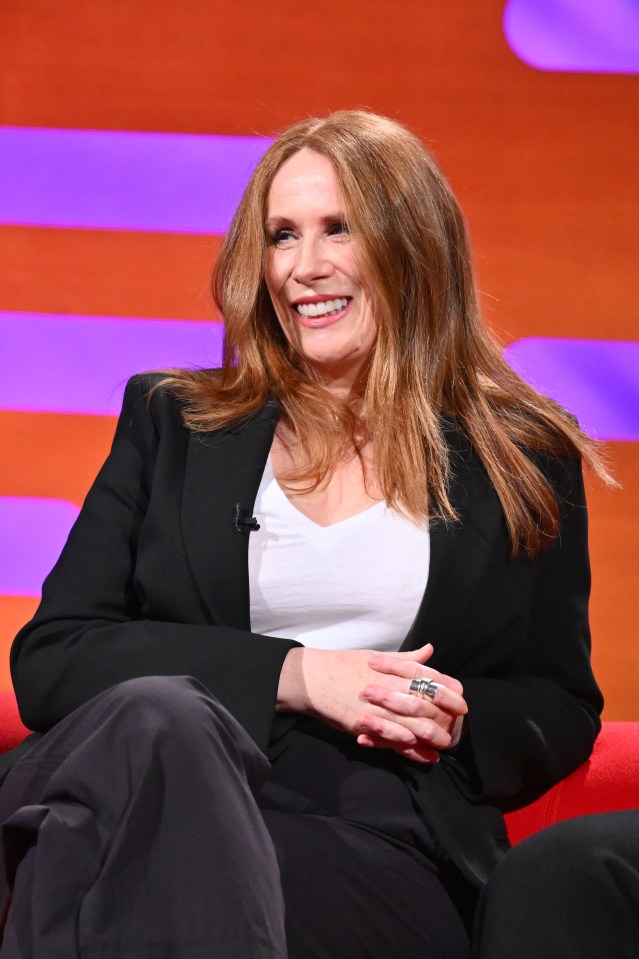 Catherine Tate seated and smiling.