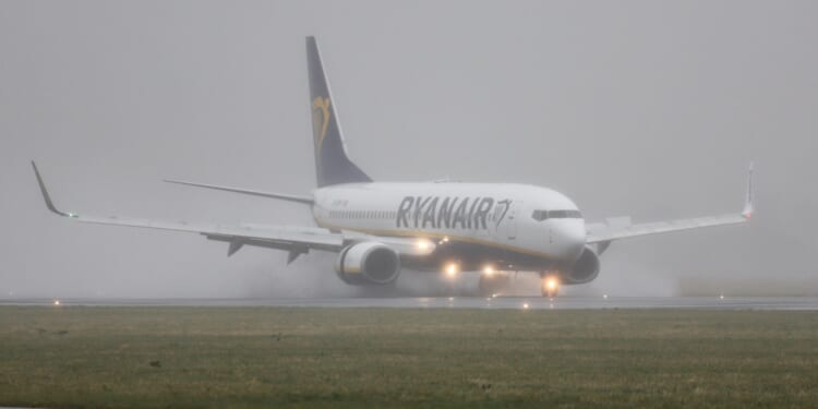 Chaos at major UK airport as dozens of flights DELAYED in heavy rain sparking chaos for pre-Xmas travellers