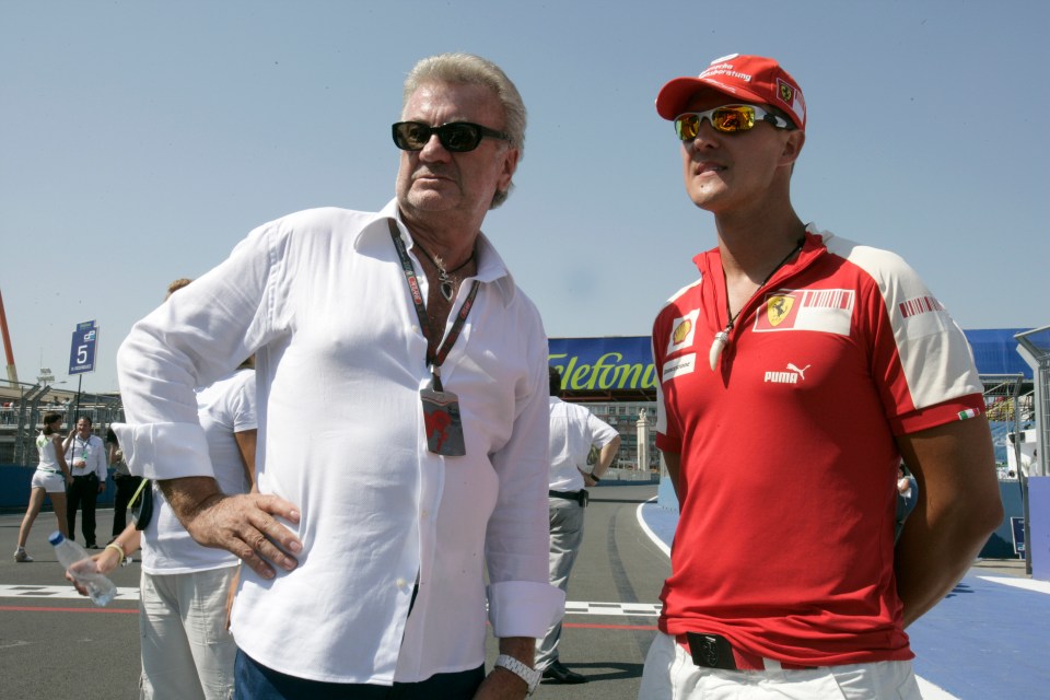 Michael Schumacher in Ferrari racing attire with Willi Weber at the 2009 GP2 Series.