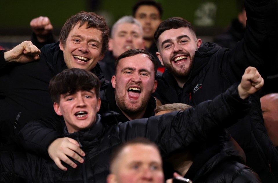 Fans cheering during the Wolverhampton Wanderers versus Manchester United Premier League match.