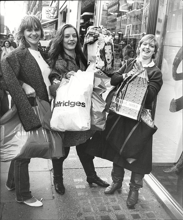 Swag: Many turned festive present buying into a social event: Pictured, three shoppers on London's Oxford Street after a designer spree