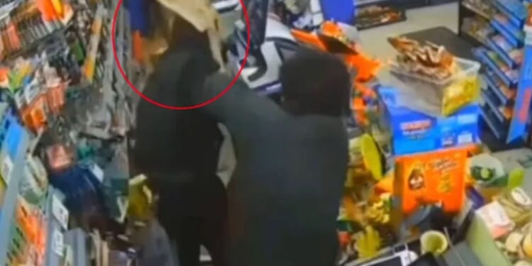 Moment shopkeeper attacks yob with SHOVEL after he 'doused shop with petrol and shouted "I'll set you on fire"'