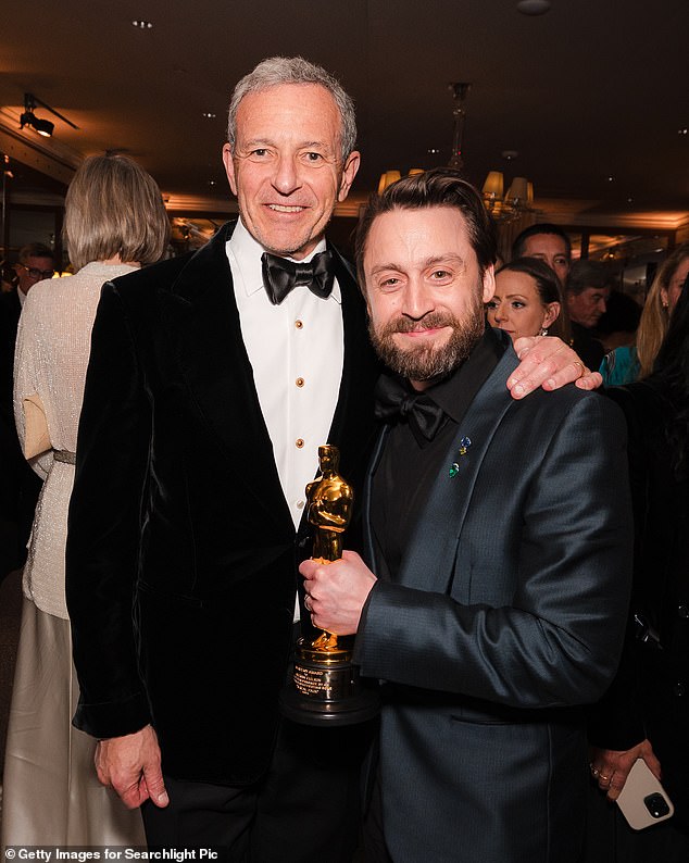 The move marks a new era for film, after 50 years of the ceremony only being available on network TV. Pictured, the CEO of ABC's parent company Disney, Bob Iger, at the awards with Best Supporting Actor winner Kiernan Culkin