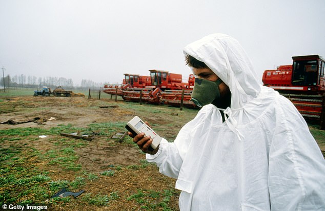 Pictured is someone measuring levels of radioactivity in the area surrounding the Chernobyl nuclear power in 1990