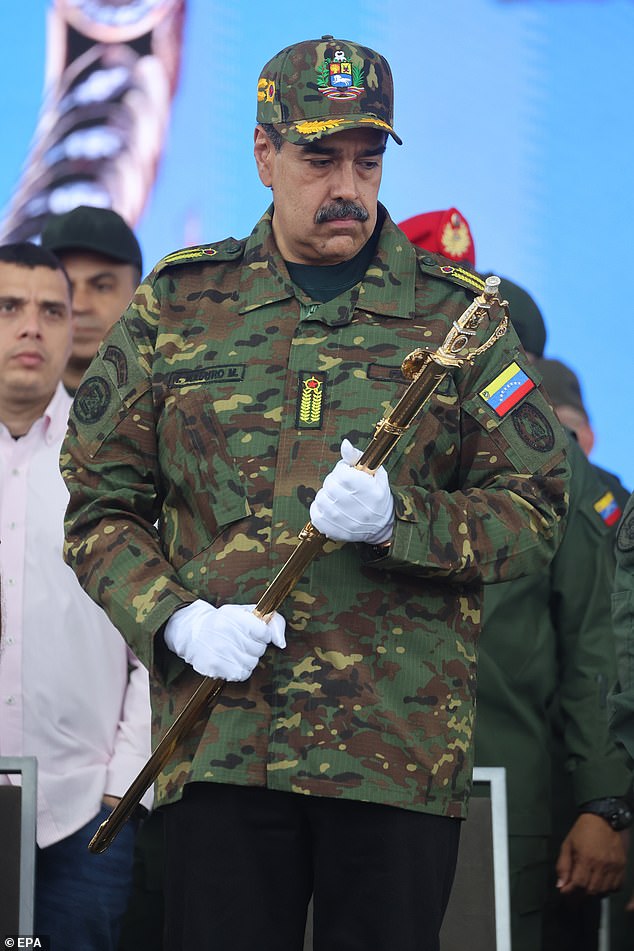 Venezuelan President Nicolas Maduro holds the Sword of Peru during an event marking the bicentennial of its delivery to Simon Bolivar, in Caracas, Venezuela, November 25
