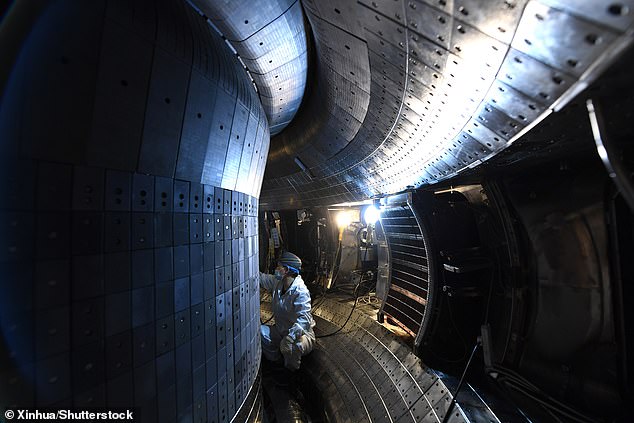 By simulating the conditions inside a tokamak reactor, researchers can find ways to make the plasma less turbulent and ensure that nuclear fusion reactions last longer. Pictured: A staff member performs an upgrade to China's experimental advanced superconducting tokamak (EAST)