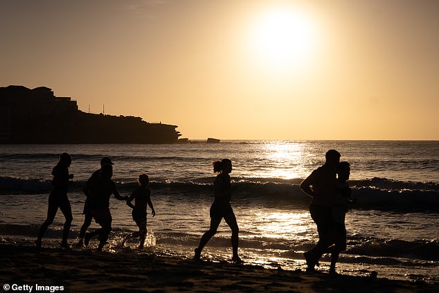 SYDNEY, AUSTRALIA - DECEMBER 18: People visit Bondi Beach during sunrise, on December 18, 2025 in Sydney, Australia. Police say at least 16 people, including one suspected gunman, were killed and more than 40 others injured when two attackers opened fire near a Hanukkah celebration at the world-famous Bondi Beach, in what authorities have declared a terrorist incident. The government is moving to tighten gun laws across the country. (Photo by Audrey Richardson/Getty Images)