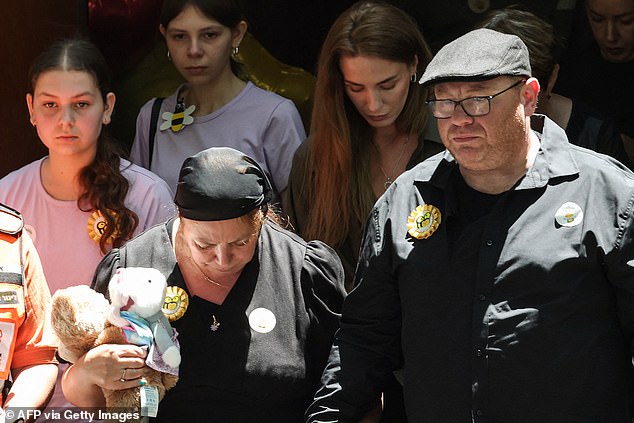 Matilda's parents, Valentyna and Michael (pictured) leave their daughter's funeral