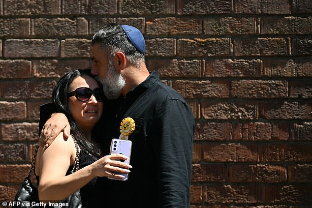 One woman could be seen crying on the shoulder of another mourner