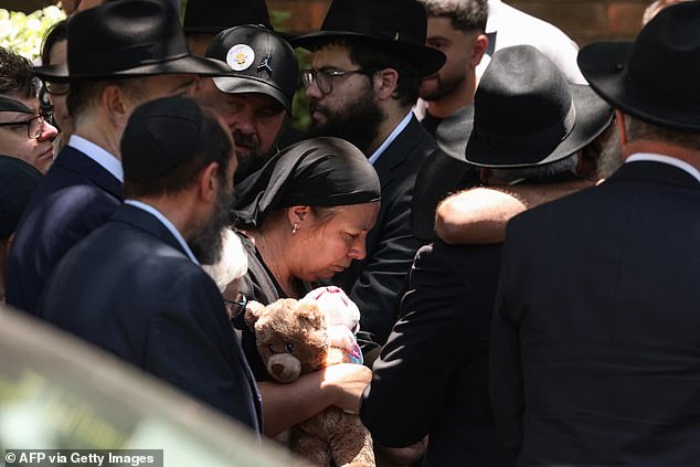 Matilda's mother is supported by other mourners