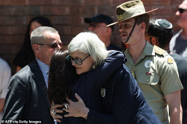 Sam Mostyn, the Governor-General of Australia, embraces a mourner