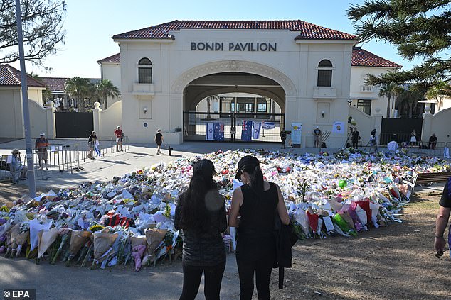 A makeshift memorial has been established by mourners at Bondi Beach in the aftermath of the tragic shooting that claimed at least 16 lives