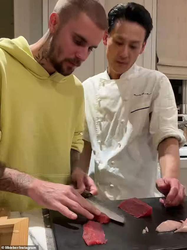 The chef supervised as Bieber carefully sliced the fish