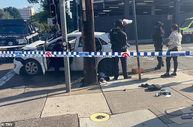A white hatchback was rammed by undercover police 4WD vehicles