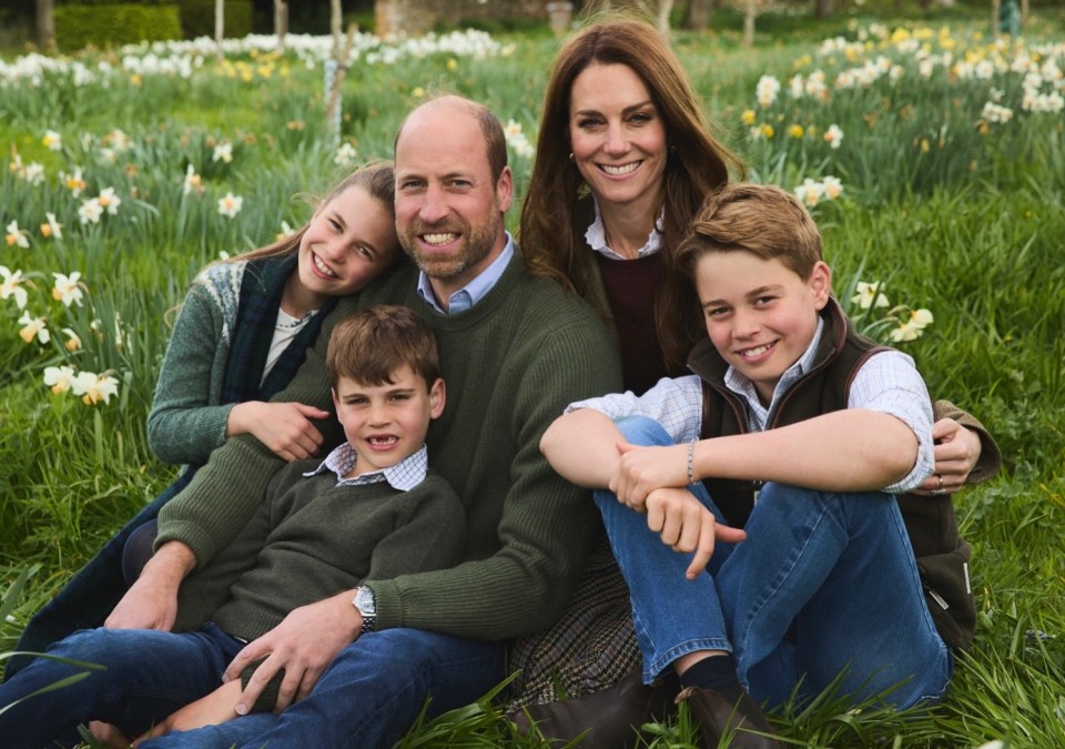 The Prince and Princess of Wales with their three children, all sitting in a field of daffodils.