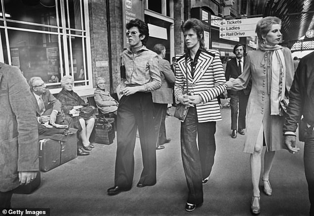 David Bowie (centre) at King's Cross Station in London with his wife Angie Bowie (right) and fashion designer Antony Price (left) on May 15, 1973