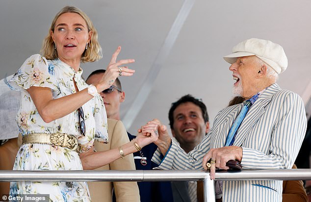 Jodie Kidd and Antony Price watch the racing as they attend day 3 'Ladies Day' of The Qatar Goodwood Festival at Goodwood Racecourse on August 1, 2024 in Chichester