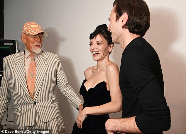 Antony Price, Lily Allen and Alex Holmes pose backstage at the 16Arlington x Antony Price Salon Show on November 17, 2025 in London