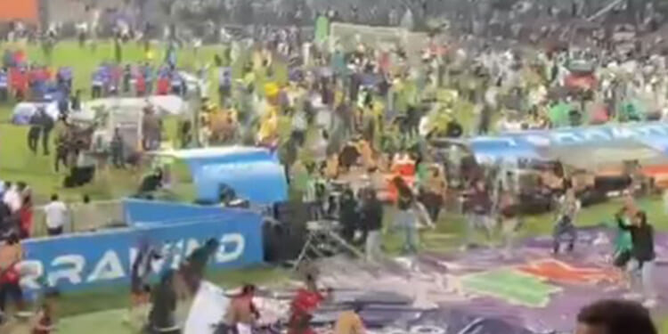 Cup final descends into chaos with pitch invasion and FENCES thrown as hundreds of supporters clash