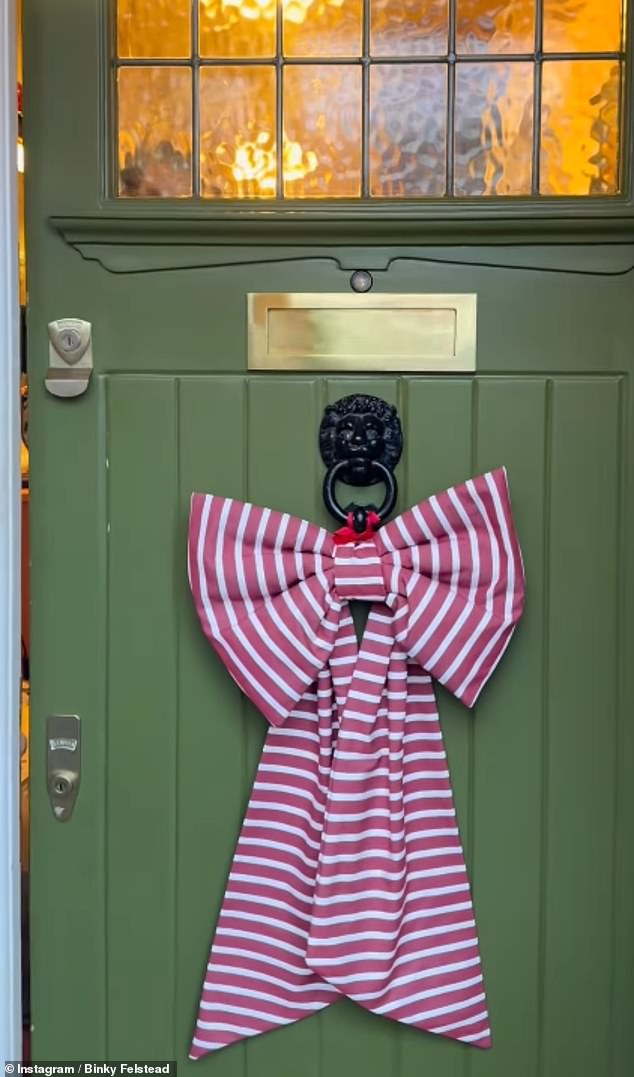 Binky channelled classic Christmas colours with a striped red and white bow on her seafoam green front door