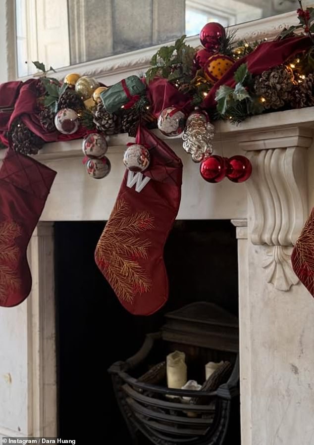 Known for her prowess in the world of interior design, Dara's marble fireplace was decorated with a wreath display, baubles and red stockings