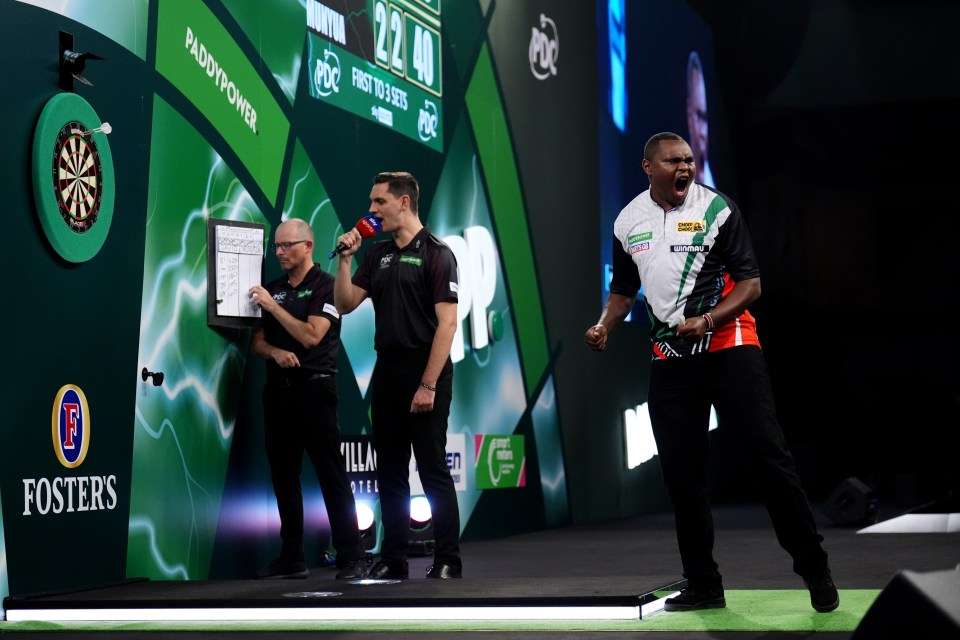 David Munyua celebrates his victory over Mike De Decker at the Paddy Power World Darts Championship.