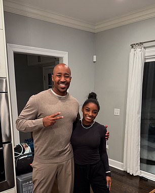 Biles poses with the breeder, who appeared to confirm the 'cropping' procedure