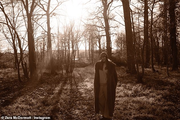 Zara beamed in a woodland wearing a warm long fur coat