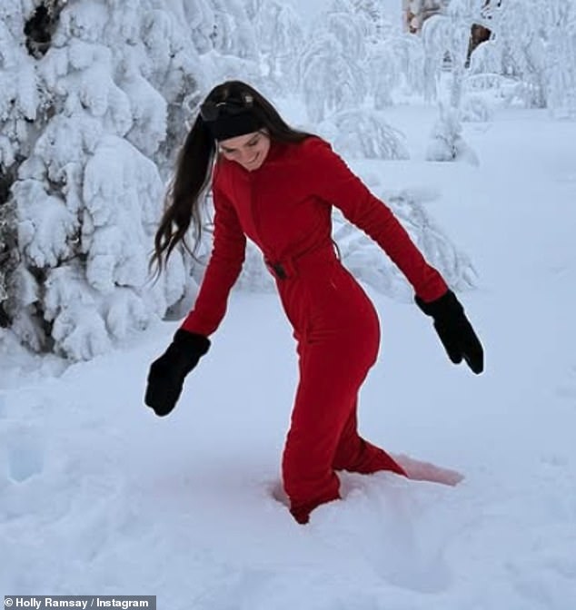 Holly posed up a storm in the outfit which was cinched at the waist with a belt and teamed with oversized shades and white boots