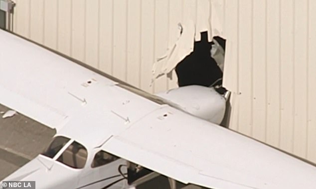 Video of the crash site showed how the plane took a went nose first into the building, resulting in a hole being left in the side of the hangar