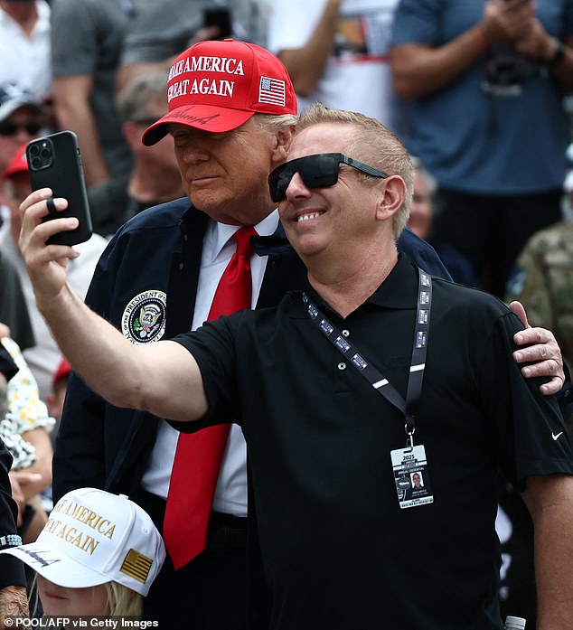 Biffle is seen taking a selfie with President Donald Trump in February in Daytona Beach, Florida