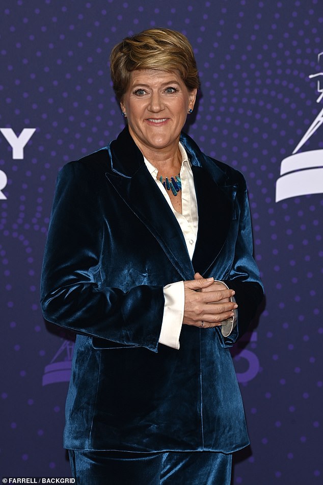 She layered the look over a white satin shirt while carrying the suits colour story into her accessories