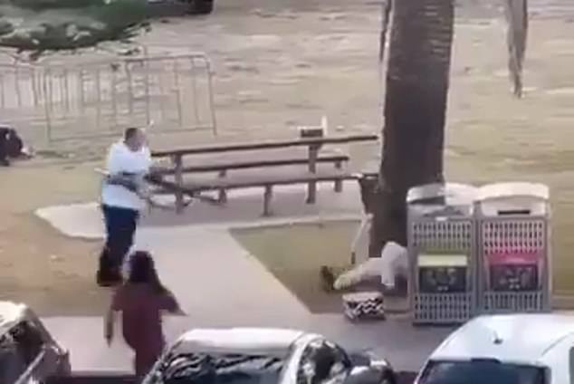 The father-of-two is pictured aiming a firearm at the elder gunman following an altercation