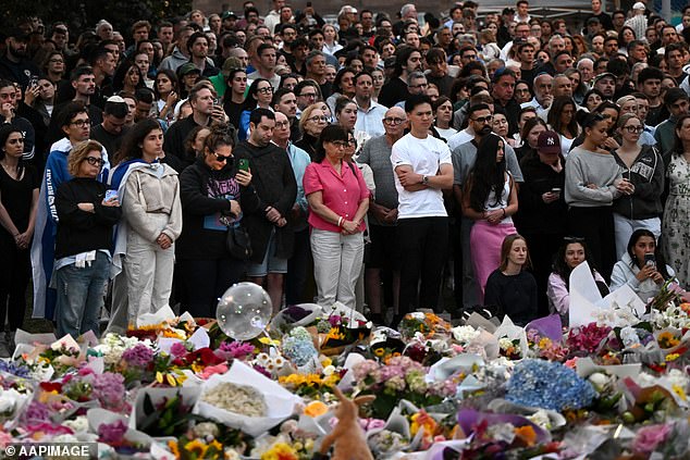 Nearly $5million has been raised to support victims and their families in the wake of the Bondi Beach shooting on Sunday night. Mourners are pictured at a vigil on Monday