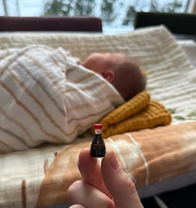 Holding up a tiny bottle of Kikkoman soy sauce, Hewitt snapped a photo of baby Scottie resting while swaddled in a blanket