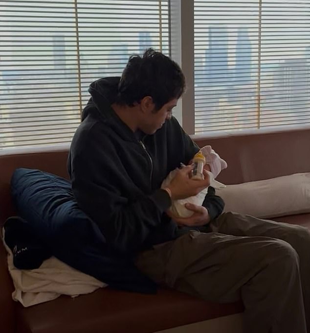 Davidson could be seen holding his baby girl in one shot