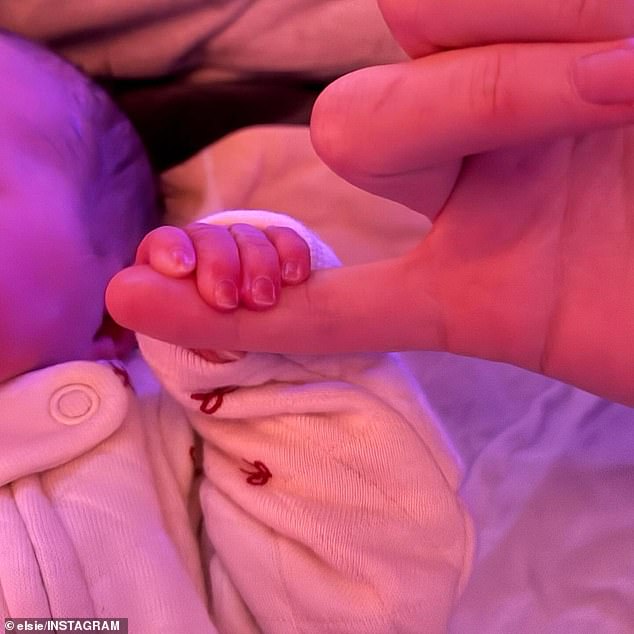 The precious newborn grabbed one of her parents' fingers with her tiny hand